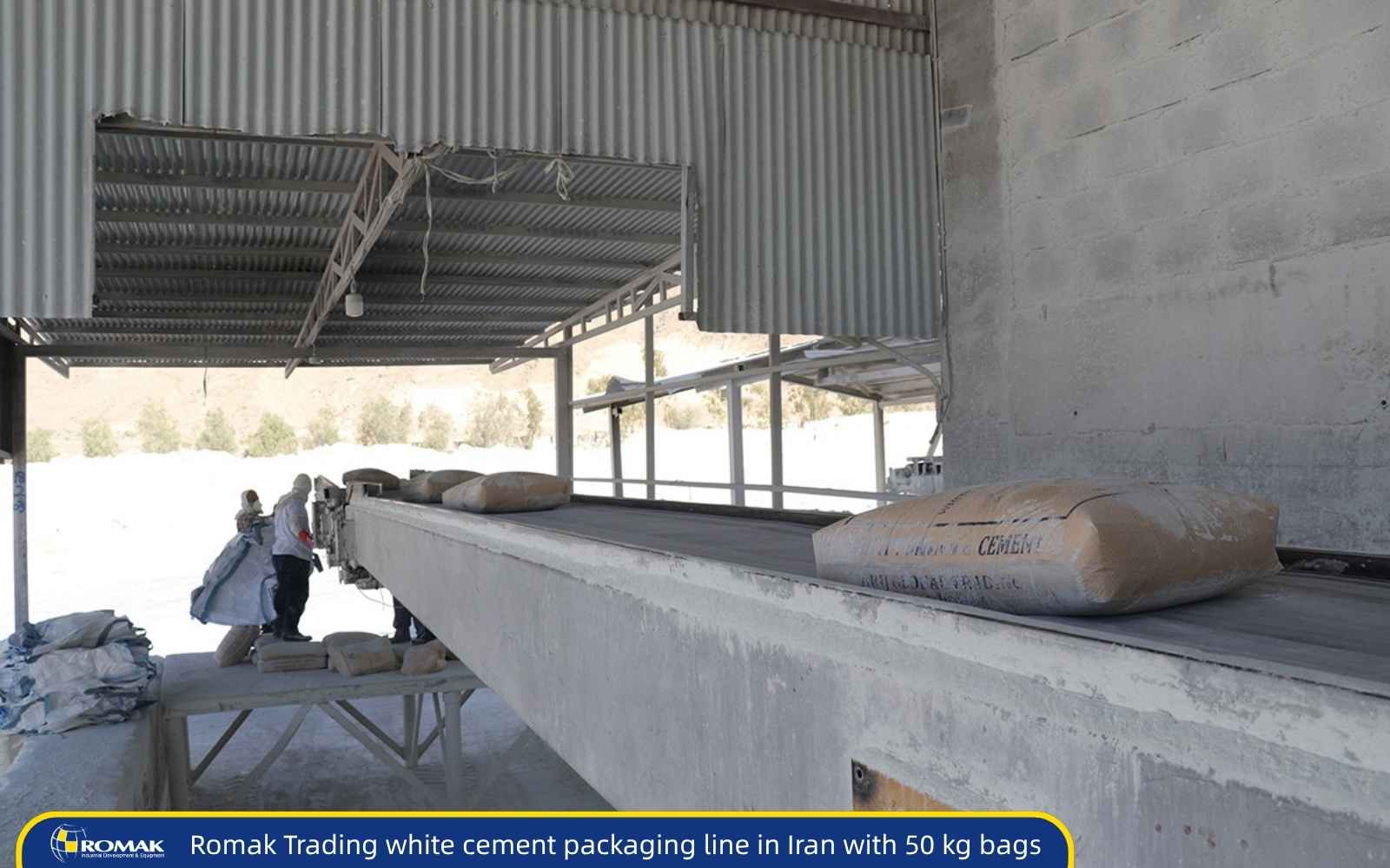 Workers loading 50 kg white cement bags onto a conveyor belt at a cement packaging facility in Iran